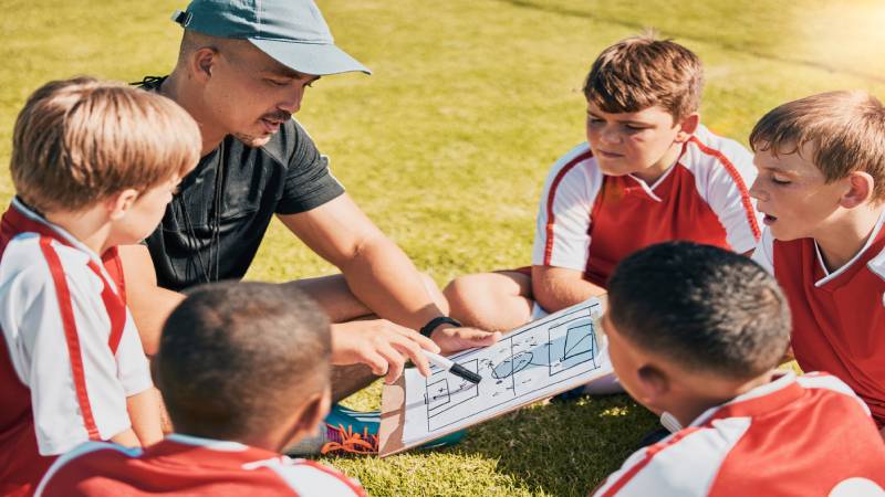 tactics-children-and-soccer-with-a-coach-and-team